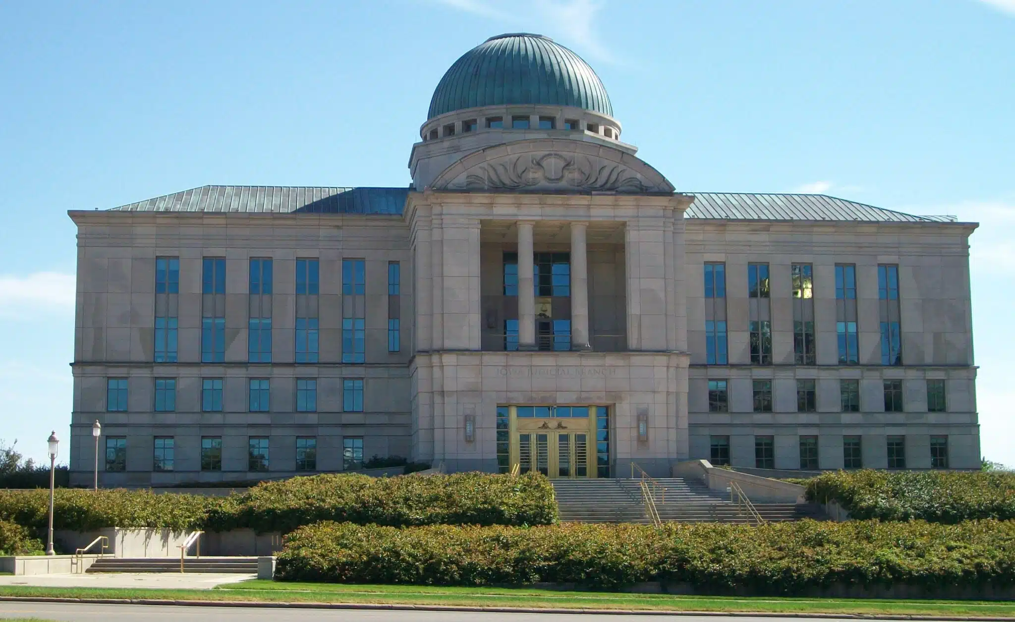 Front of the Iowa Judicial Branch Building, with a domed roof, columns, and entrance steps.