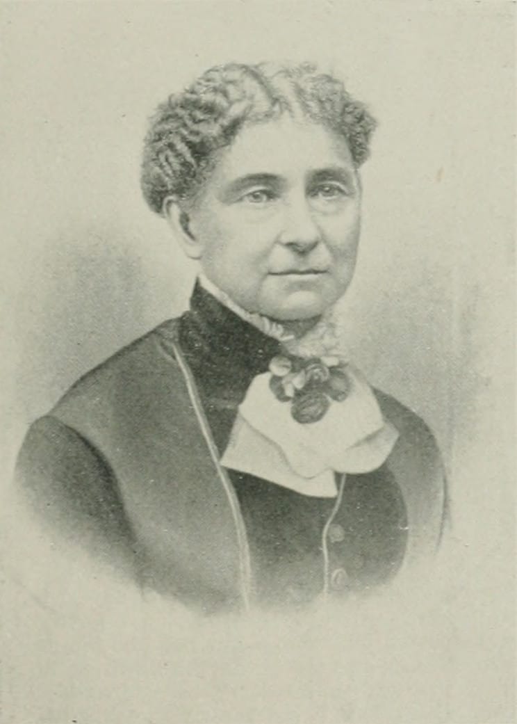 Engraved portrait of Amelia Bloomer with a bow at her collar.
