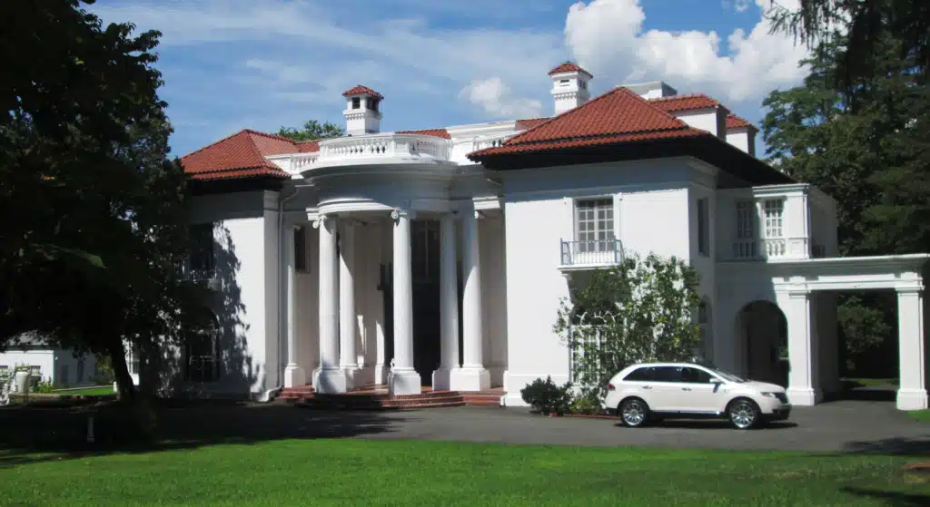 Villa Lewaro viewed from the northeast, with its columned entrance and lawn.