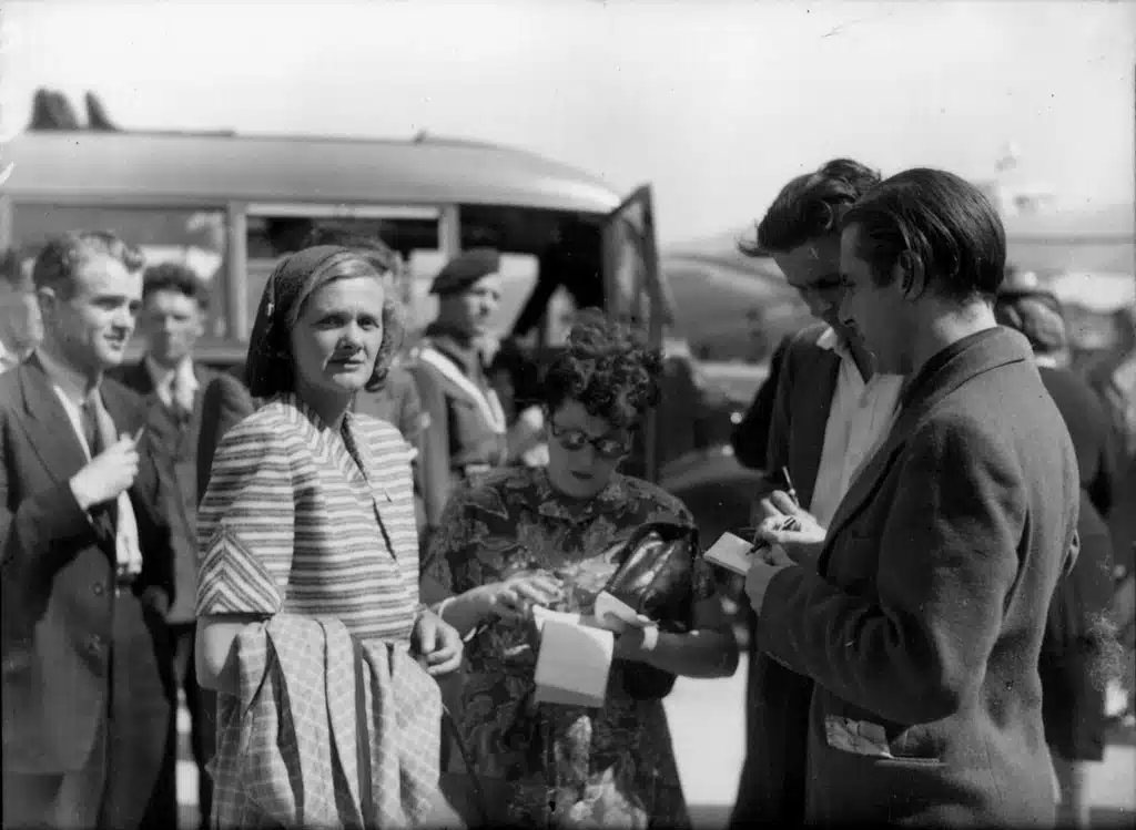 Daphne du Maurier among people greeting her at Schiphol Airport.