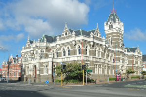 Dunedin Law Courts, photographed in 2023 | Amazing Women In History Dunedin Law Courts seen from the street, with a stone facade, ornate windows, and a corner tower.