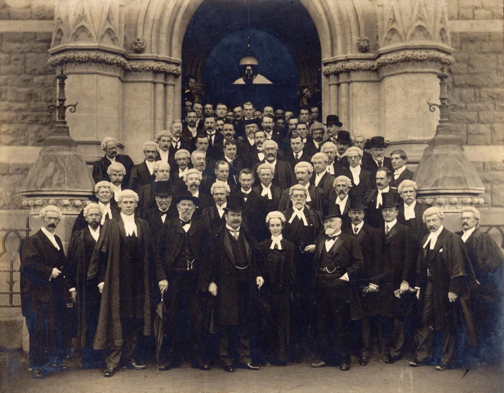 Ethel Benjamin at the opening of Dunedin Law Courts, 1902 | Amazing Women In History Ethel Benjamin stands at the front of a group of lawyers outside Dunedin Law Courts in 1902.
