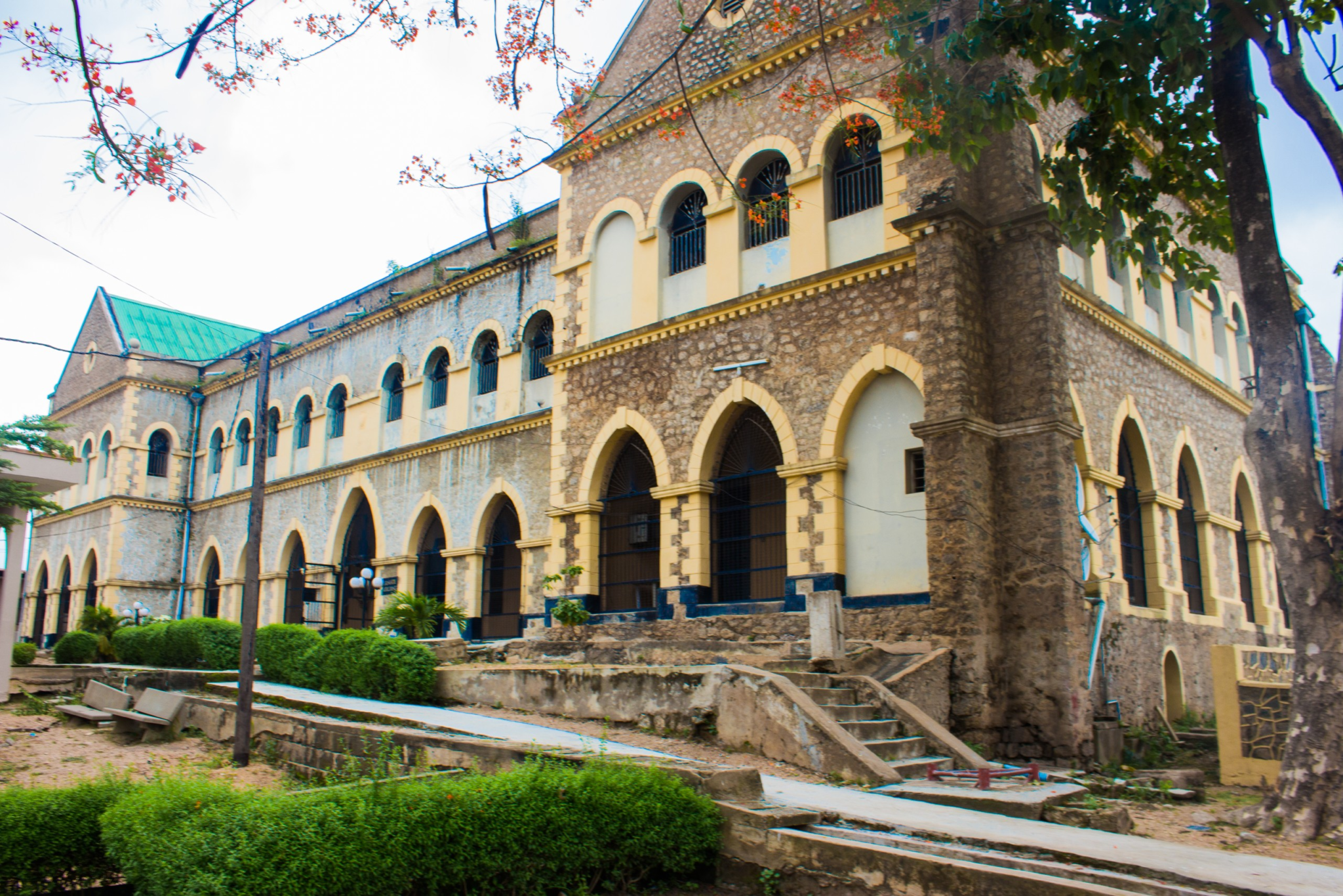 Abeokuta Grammar School old hall in 2016 | Amazing Women In History The old hall of Abeokuta Grammar School, a two-storey building with arched windows and a tower.