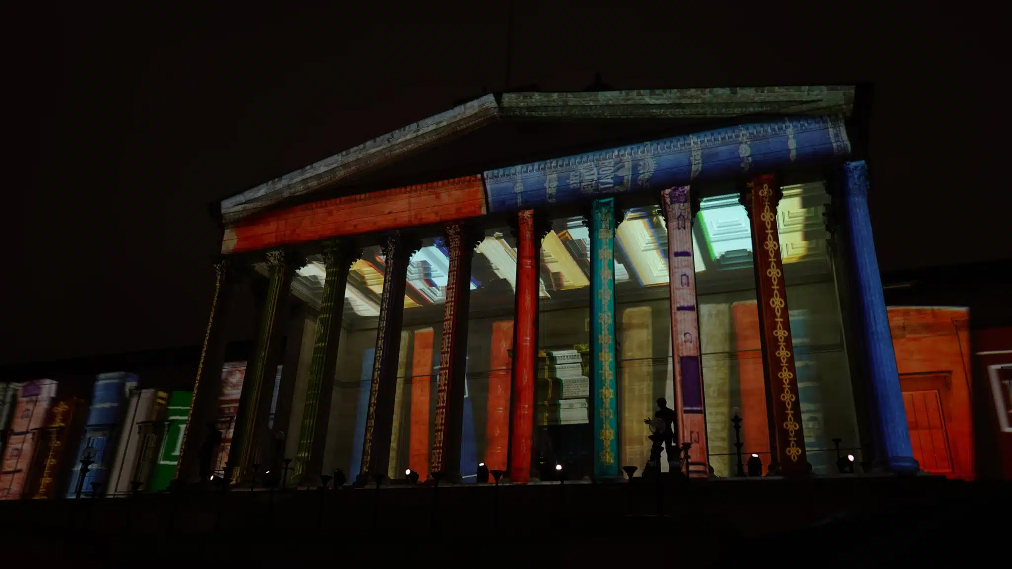 University College London's main building illuminated at night.