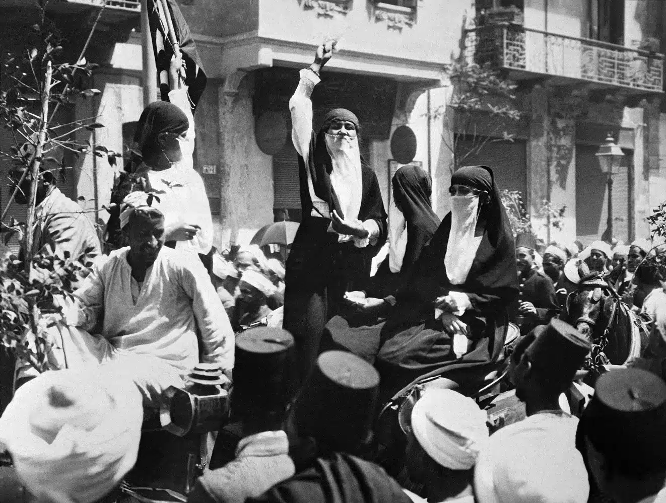 Egyptian women gather as a woman addresses the crowd from an elevated position.