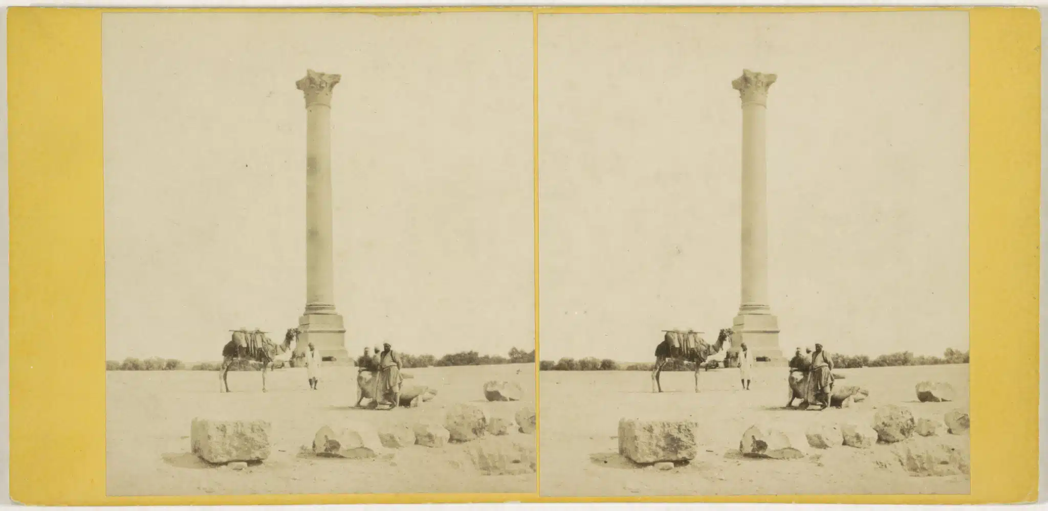 Historical photograph of Pompey's Pillar and surrounding ruins in Alexandria.