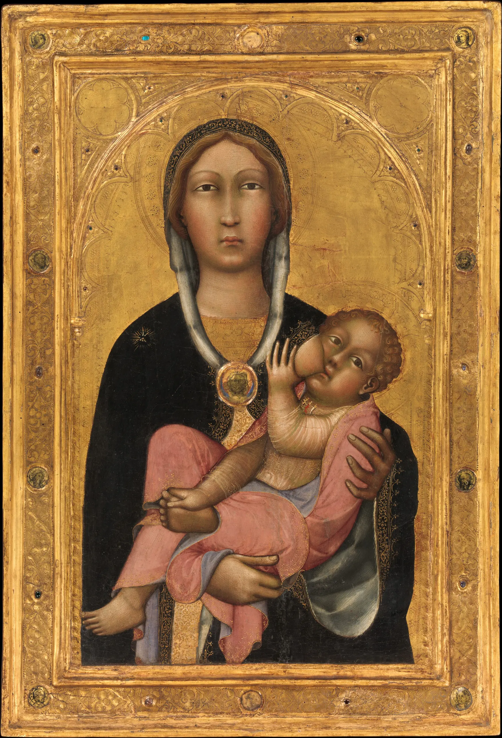 Medieval painting of Mary holding and nursing the Christ Child, surrounded by an ornate gold frame.