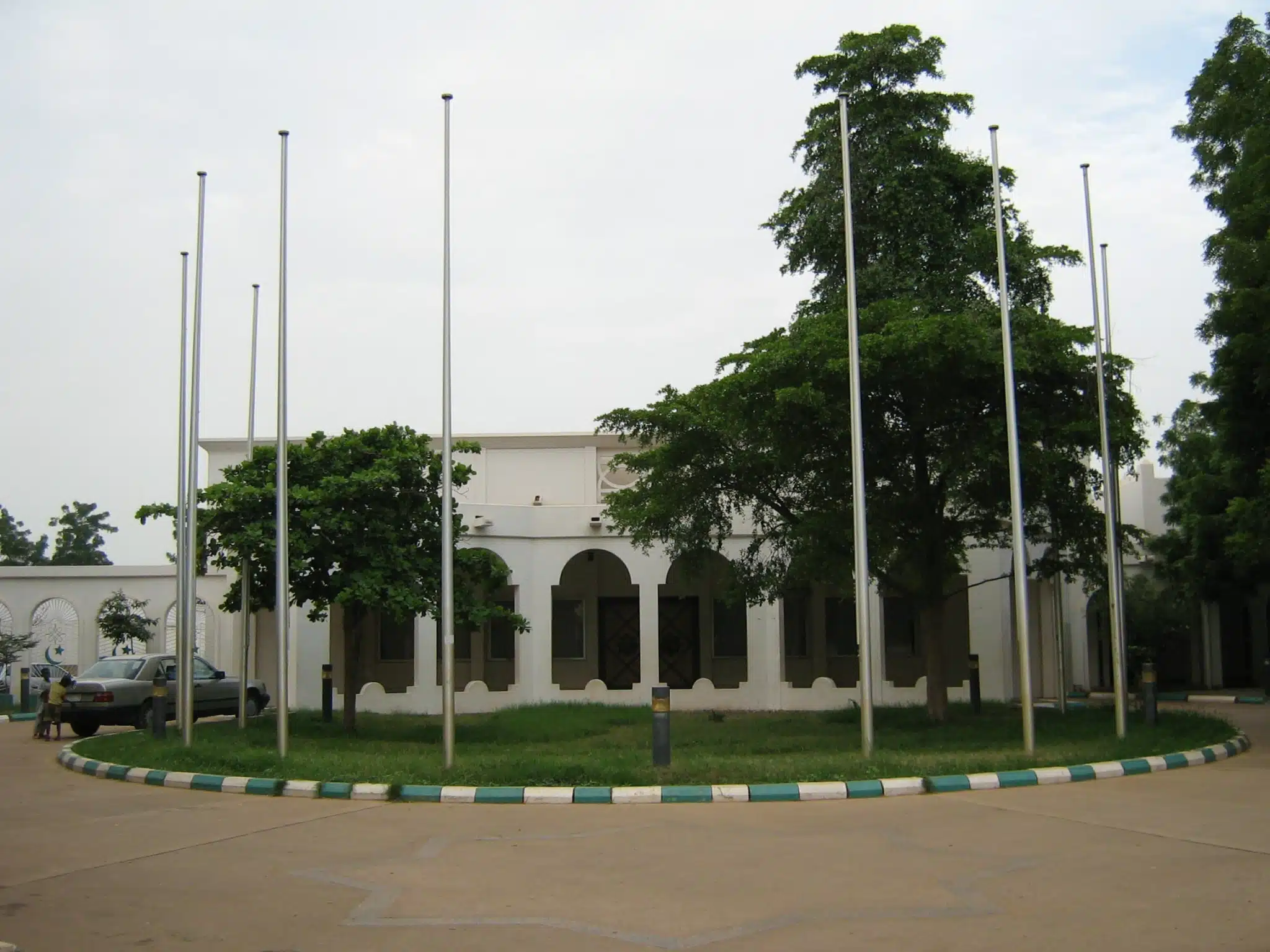 The entrance to the Sultan's palace in Sokoto, with trees and flagpoles.