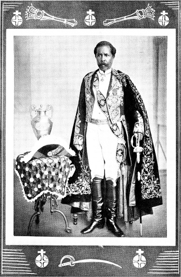 Rainilaiarivony portrait | Amazing Women In History Rainilaiarivony stands in an embroidered coat beside an ornate chair in a framed historical portrait.