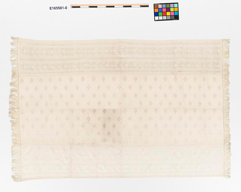 Ranavalona III’s cream-colored silk gift to Grover Cleveland | Amazing Women In History A cream silk lamba with woven diamonds and geometric bands, fringed along its short edges.