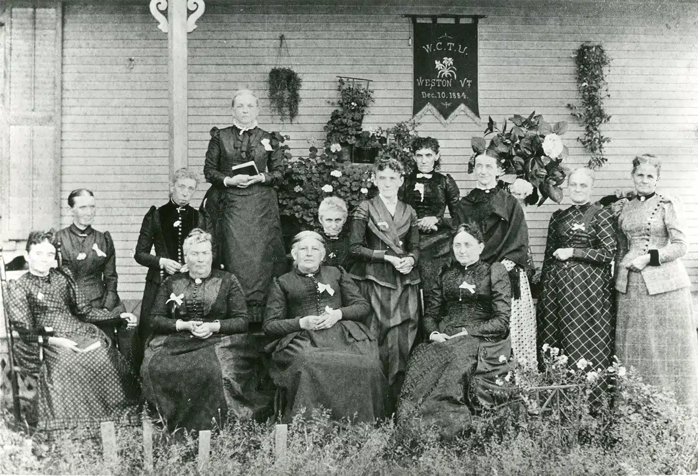 Members of the Weston Woman's Christian Temperance Union pose outside a house.